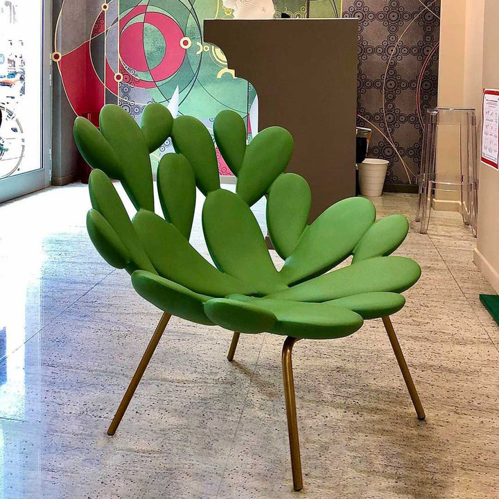 Filicudi armchair by Marcantonio, sculpted green upholstery with gold legs in a modern setting