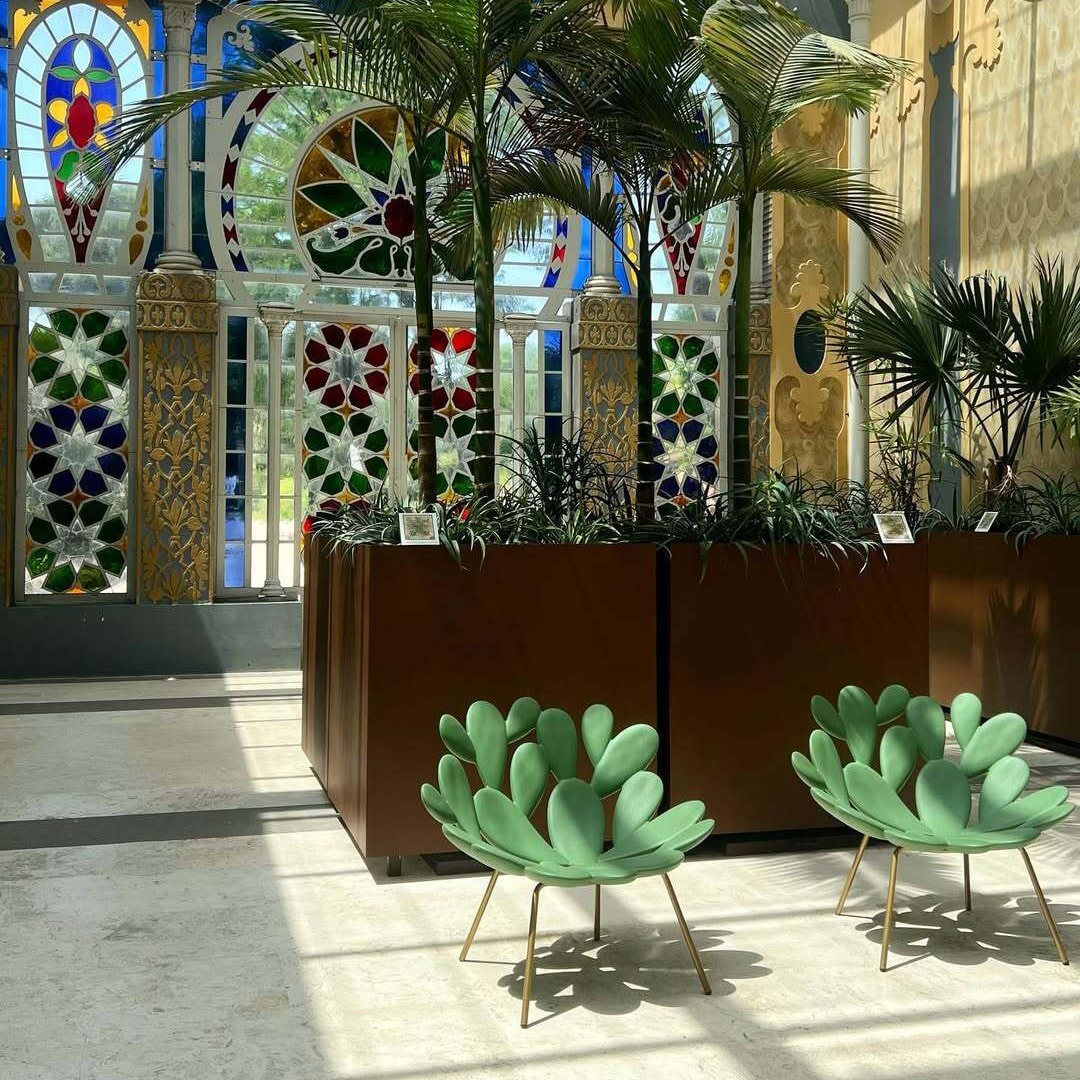 Filicudi armchairs by Marcantonio in green polyethylene, gold legs, in sunlit conservatory