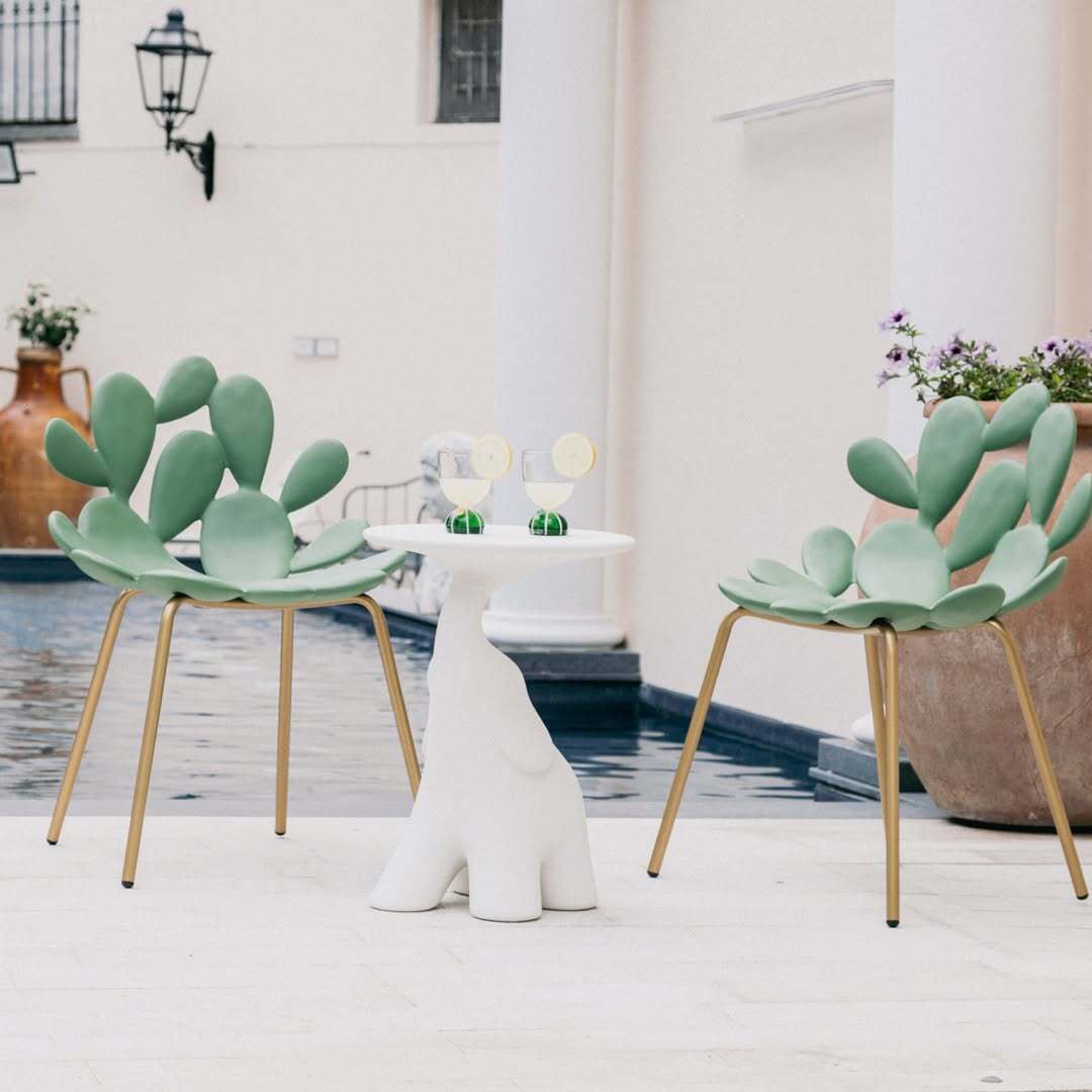 Filicudi chairs in matte green with gold legs by Marcantonio, poolside, sculptural table
