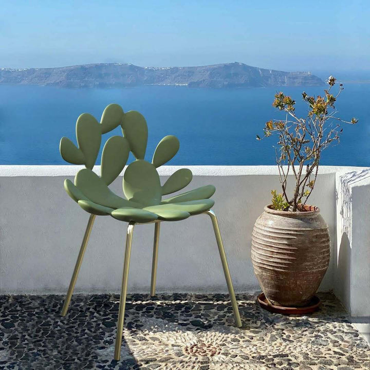 Qeeboo Filicudi green designer chair by Marcantonio with sculptural form, brass legs, outdoor setting