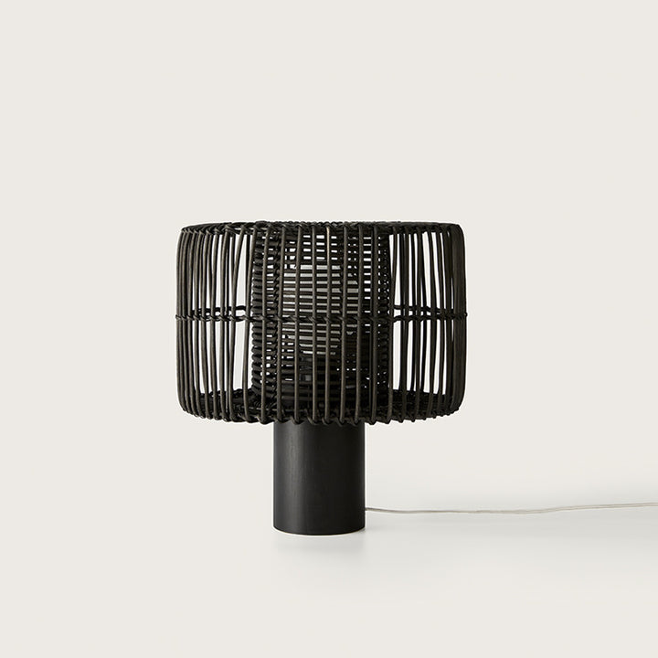 Hedula Table Lamp in black with open rattan fibre shade on a cylindrical wooden base, unlit, by Aromas del Campo
