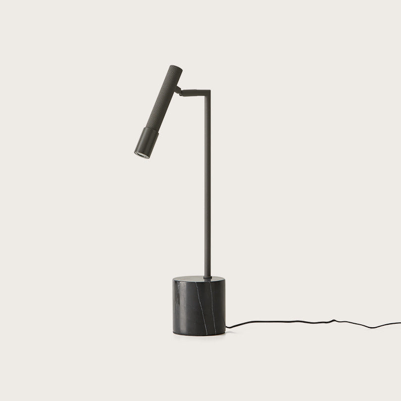 Ycro Table Lamp in Matt Black, slim adjustable spot arm on a black marble cylinder base, unlit, by Aromas del Campo