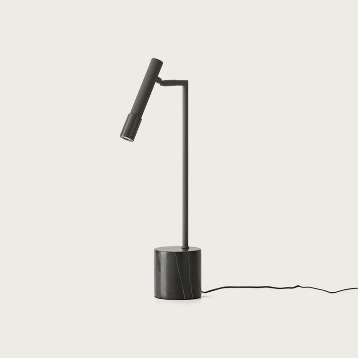 Ycro Table Lamp in Matt Black, slim adjustable spot arm on a black marble cylinder base, unlit, by Aromas del Campo