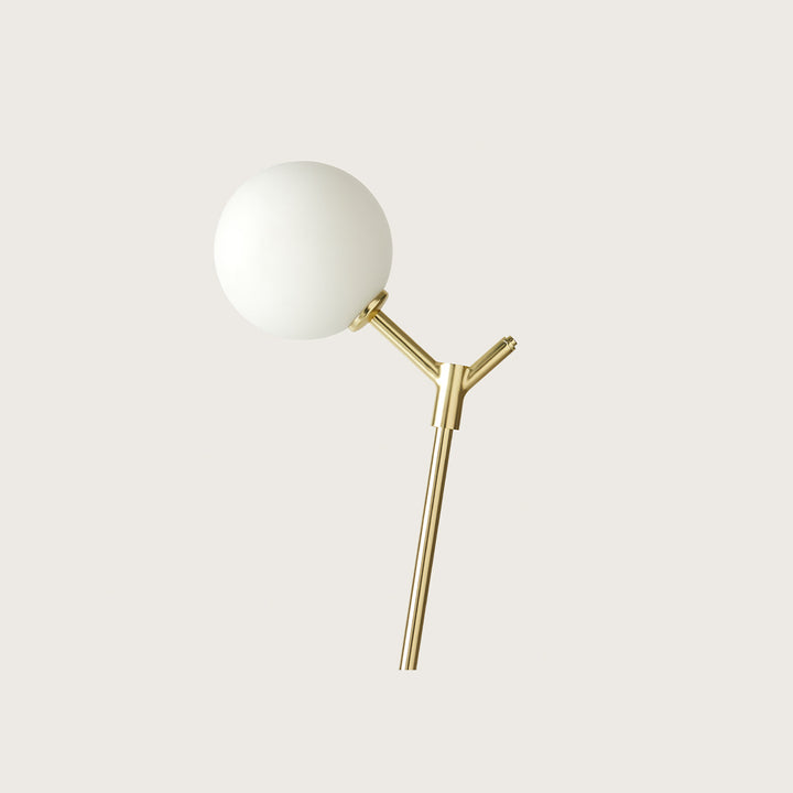 Atom Table Lamp in matt brass, close-up of the opal glass globe on the angled stem