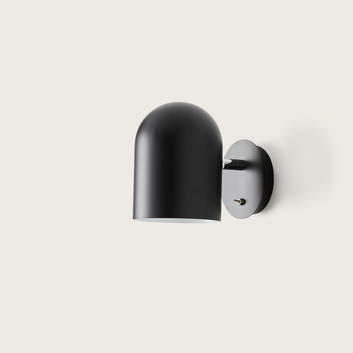 Luca Wall Lamp in matt black, side view of the rounded shade and wall plate with toggle switch