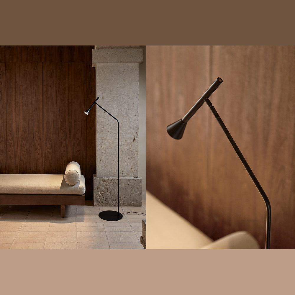 Lyb Floor Lamp in black beside a cushioned daybed and stone pillar, with a close-up of its cone head