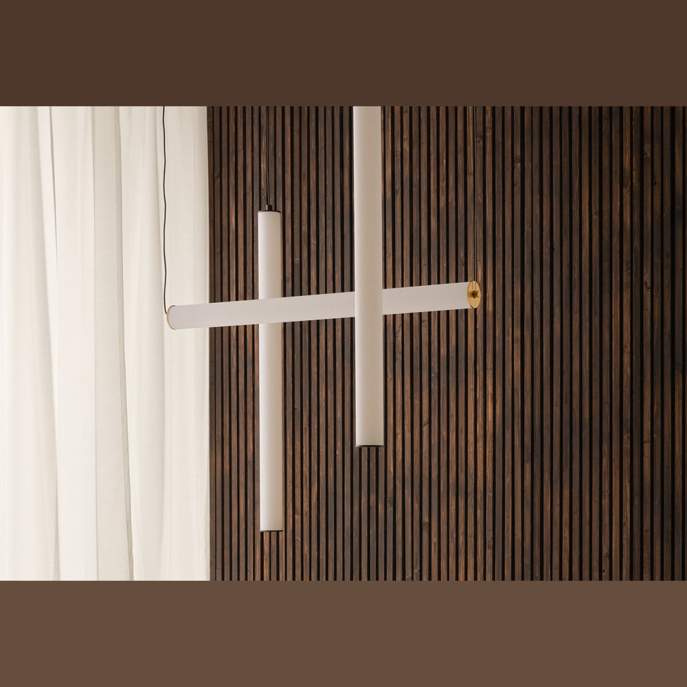 Tube Pendant Lamp, crossed horizontal and vertical opal tubes against a dark wood slat wall
