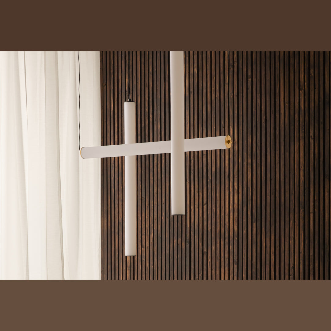 Tube Pendant Lamp, crossed horizontal and vertical opal tubes against a dark wood slat wall