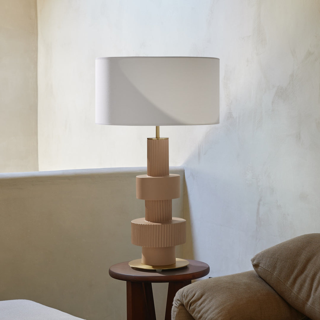 Babel Table Lamp with white shade on a dark wood side table beside a brown sofa against a limewashed wall