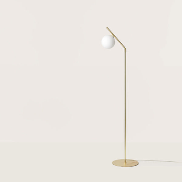 Endo Floor Lamp in a matt brass finish with opal globe on a slim stem and round base, side view