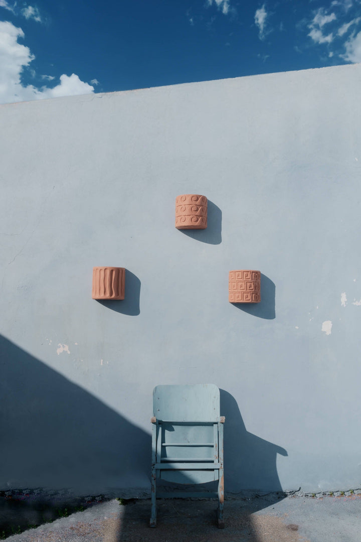 Seletti Magna Graecia Terracotta Wall Vase Dorico, three Magna Graecia wall vases on a blue wall
